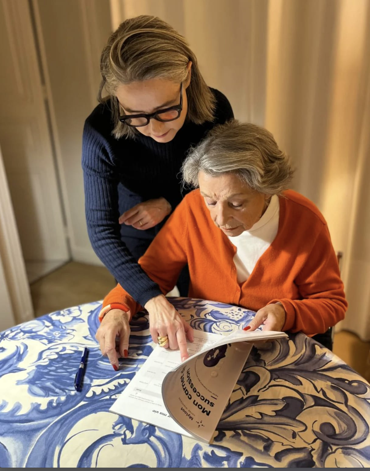 A mother and her grandmother filling The Legacy Book together